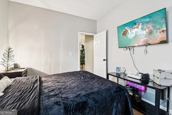 a bedroom with a bed and a flat screen tv