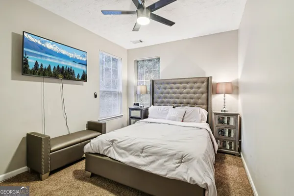a bedroom with a bed and a wall painting