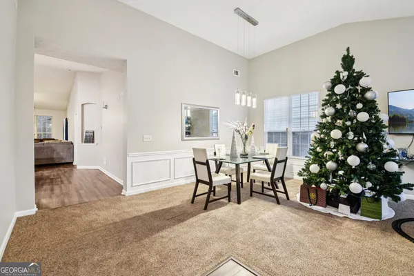 a view of a livingroom with furniture and stairs
