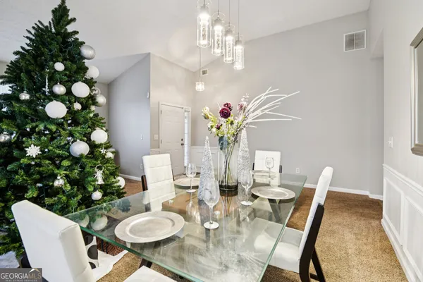 a view of a dining room with furniture and wooden floor