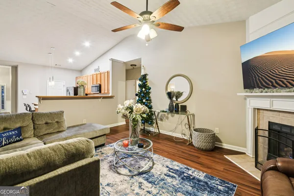 a living room with furniture a fireplace and a chandelier