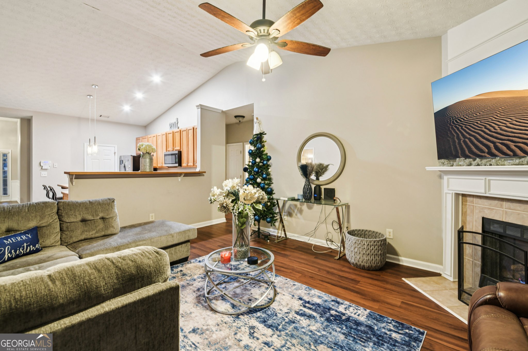 564 Goldfinch Way Stockbridge, GA 30281 - Photo 6 of 31 a living room with furniture a fireplace and a chandelier