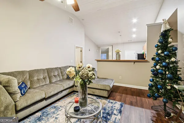 a living room with furniture and a potted plant