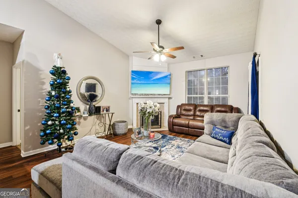a living room with furniture a chandelier and a fireplace