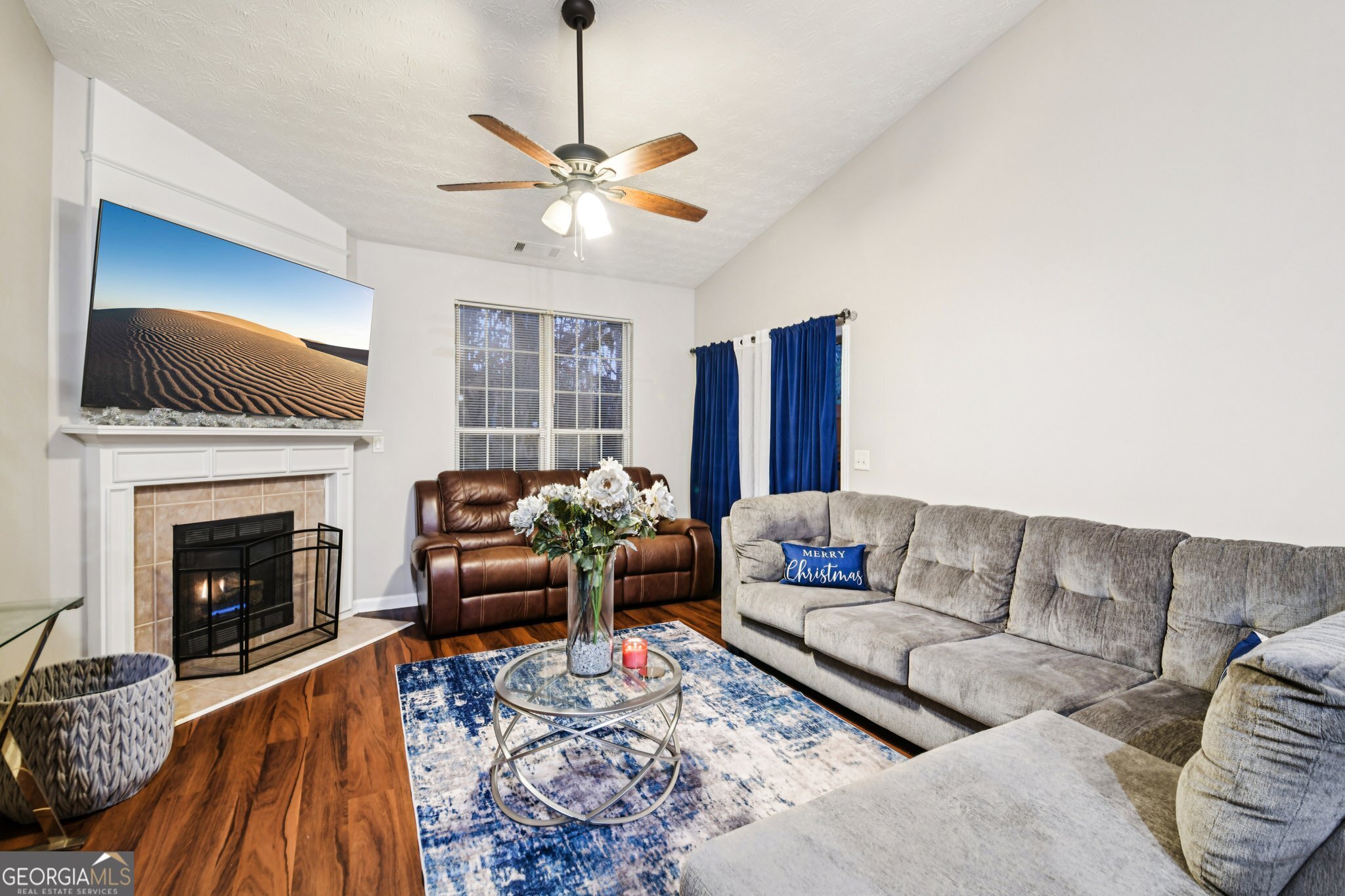 564 Goldfinch Way Stockbridge, GA 30281 - Photo 9 of 31 a living room with furniture a fireplace and a flat screen tv