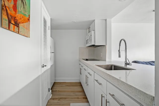 a kitchen with a refrigerator and cabinets