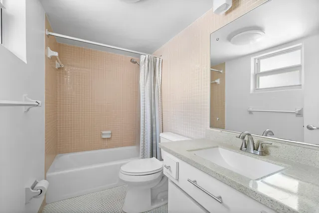 a front view of a house with a yard and potted plants