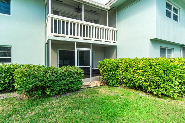 a view of a hallway with wooden floor and entryway