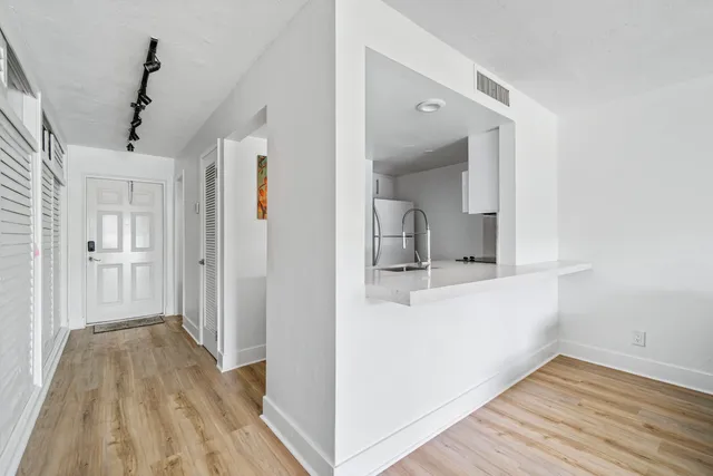 a kitchen with stainless steel appliances kitchen island granite countertop a sink and cabinets