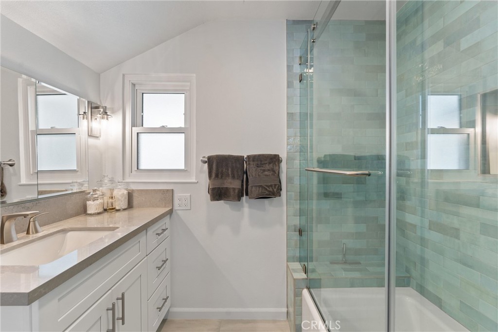 280 Tivoli Drive Long Beach, CA 90803 - Photo 15 of 22 a bathroom with a granite countertop sink a shower and a mirror