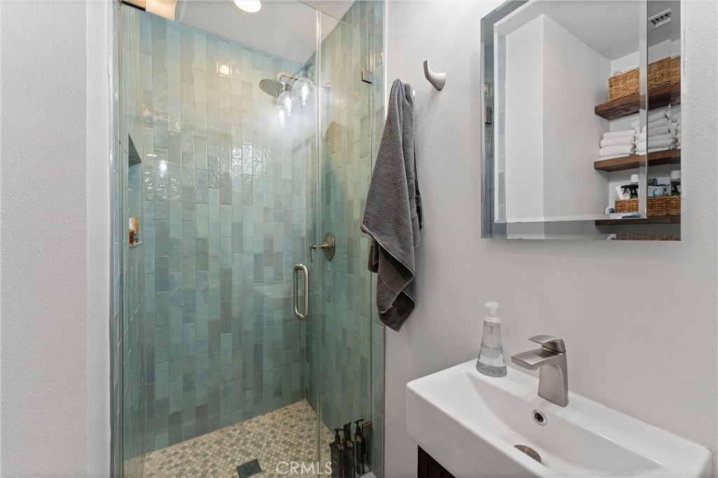 280 Tivoli Drive Long Beach, CA 90803 - Photo 16 of 22 a bathroom with a sink and a mirror
