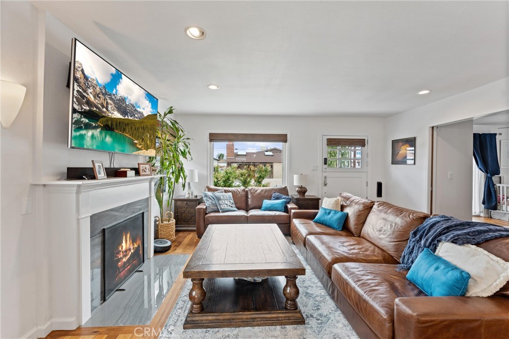 280 Tivoli Drive Long Beach, CA 90803 - Photo 4 of 22 a living room with furniture a large window and a fireplace