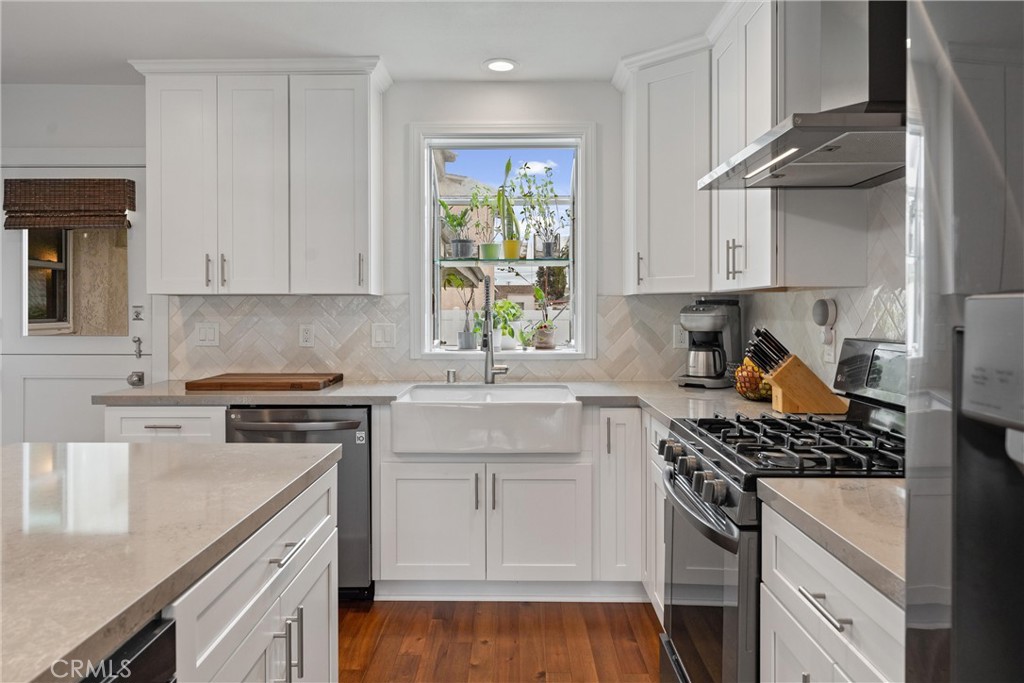 280 Tivoli Drive Long Beach, CA 90803 - Photo 6 of 22 a kitchen with stainless steel appliances white cabinets and a stove top oven