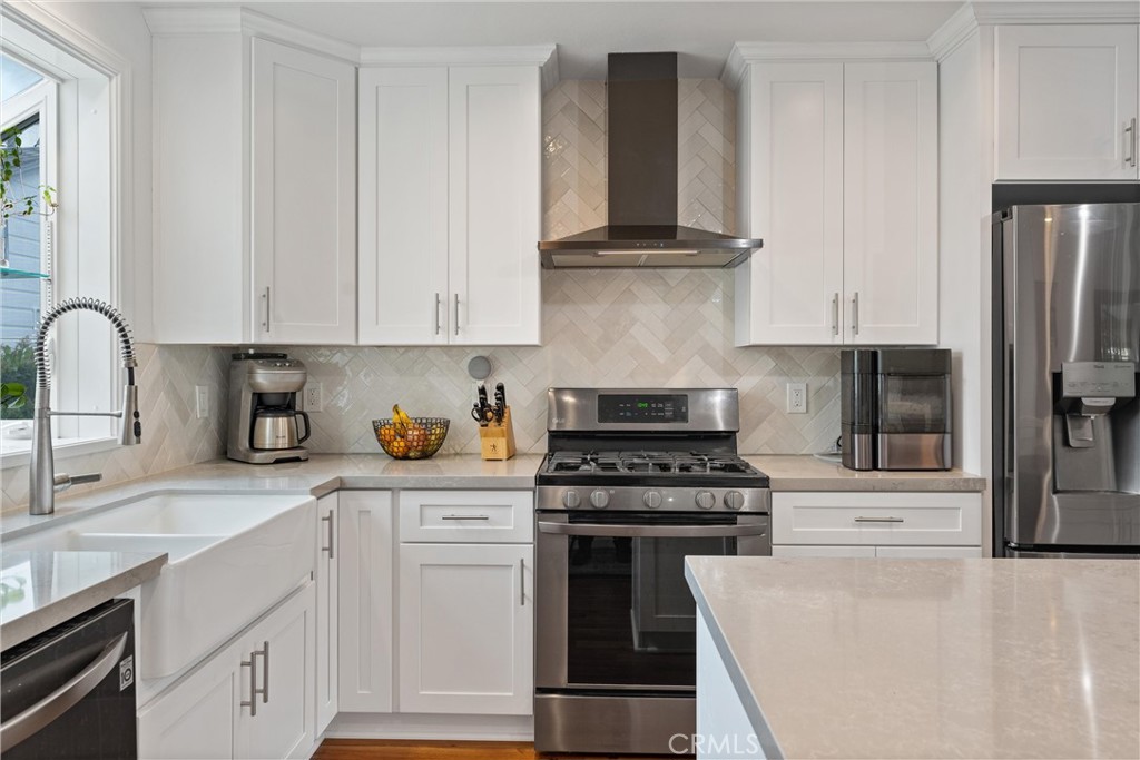 280 Tivoli Drive Long Beach, CA 90803 - Photo 7 of 22 a kitchen with cabinets appliances and a sink