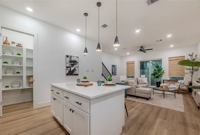 a very nice looking living room with kitchen island furniture and a wooden floor