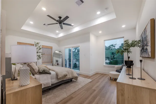 a bedroom with furniture and a large window