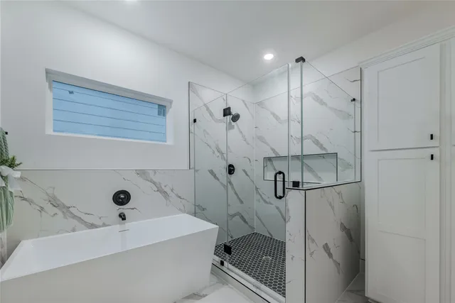 a bathroom with a bathtub and shower