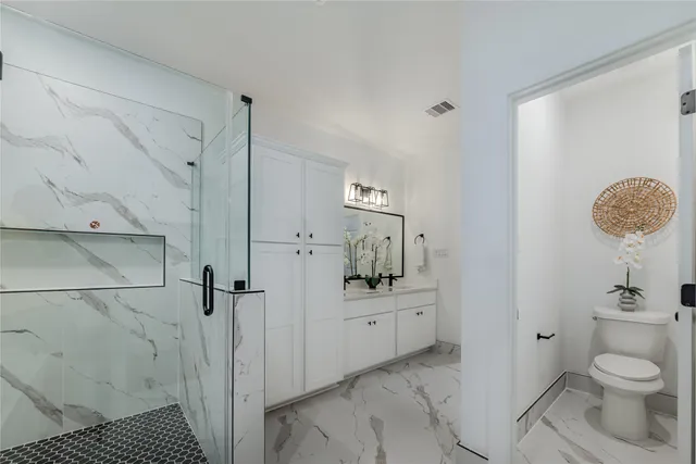 a bathroom with a sink toilet and shower