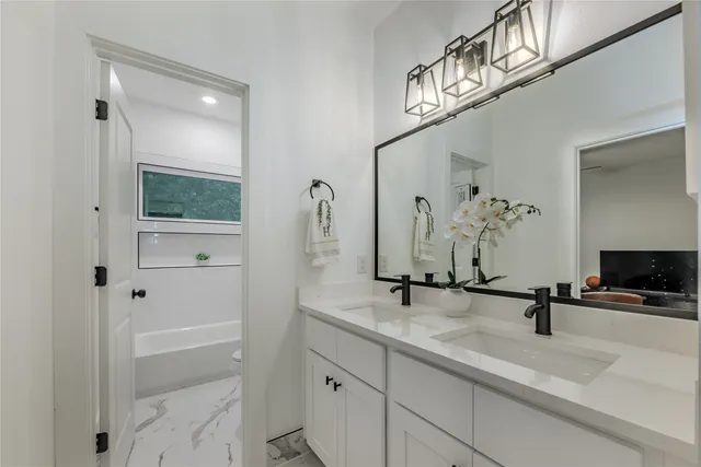 a bathroom with a sink a mirror and shower