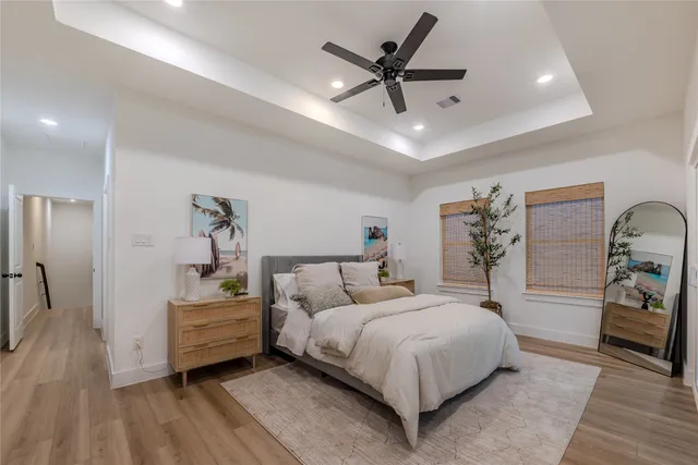 a spacious bedroom with a bed and a ceiling fan