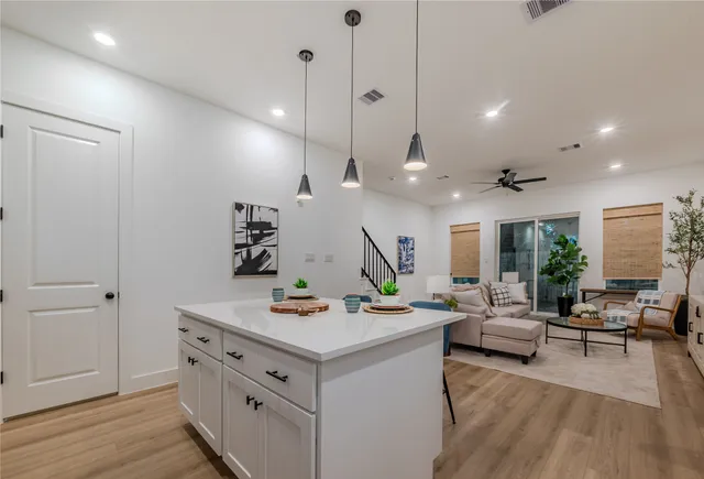 a view of a livingroom with furniture and a ceiling fan