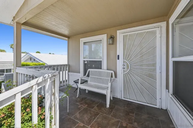 a living room with furniture a flat screen tv and a couch