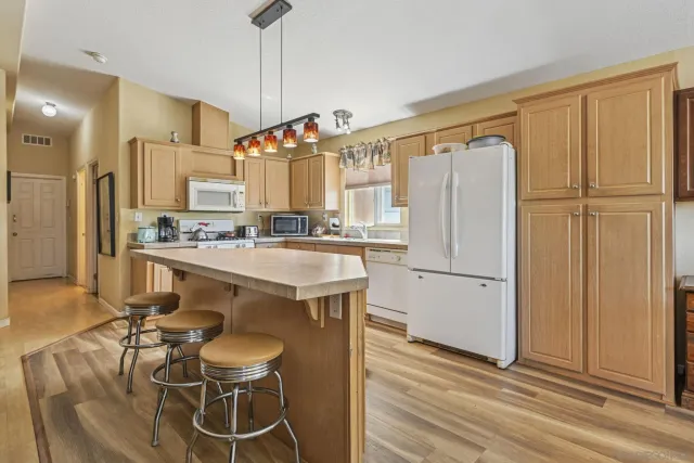 a kitchen with a stove a sink and a refrigerator