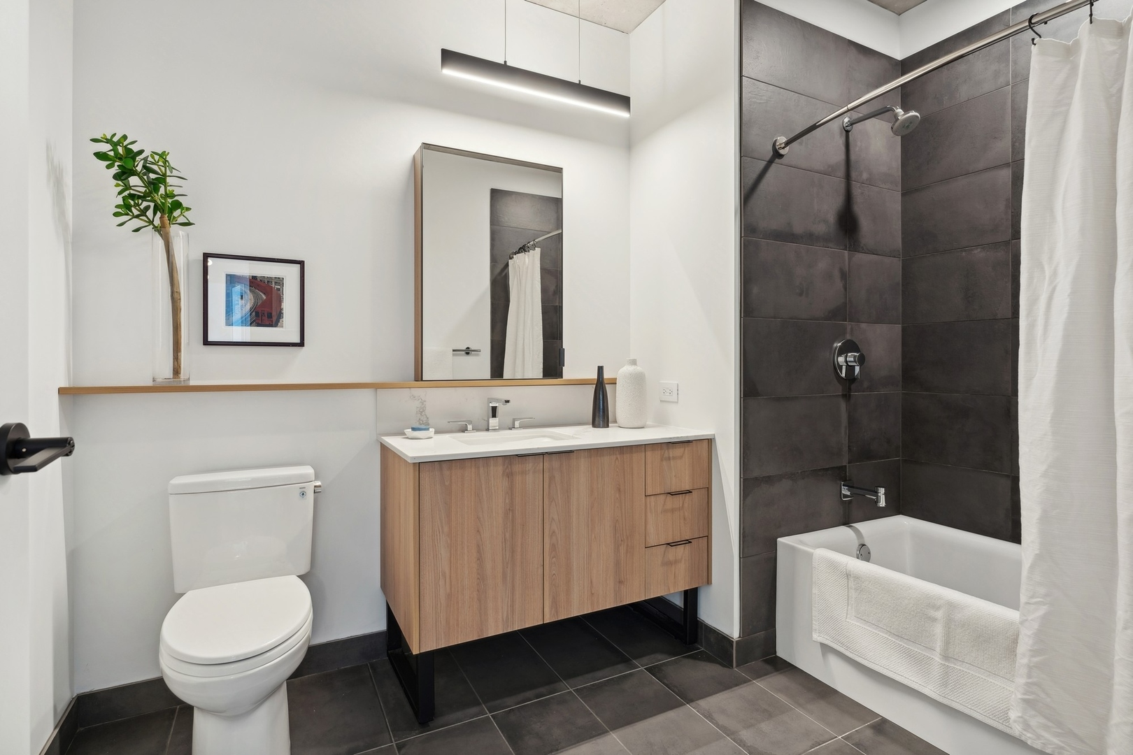 234 West Polk Street, Unit 3503 Chicago, IL 60607 - Photo 17 of 36 a bathroom with a sink toilet and shower