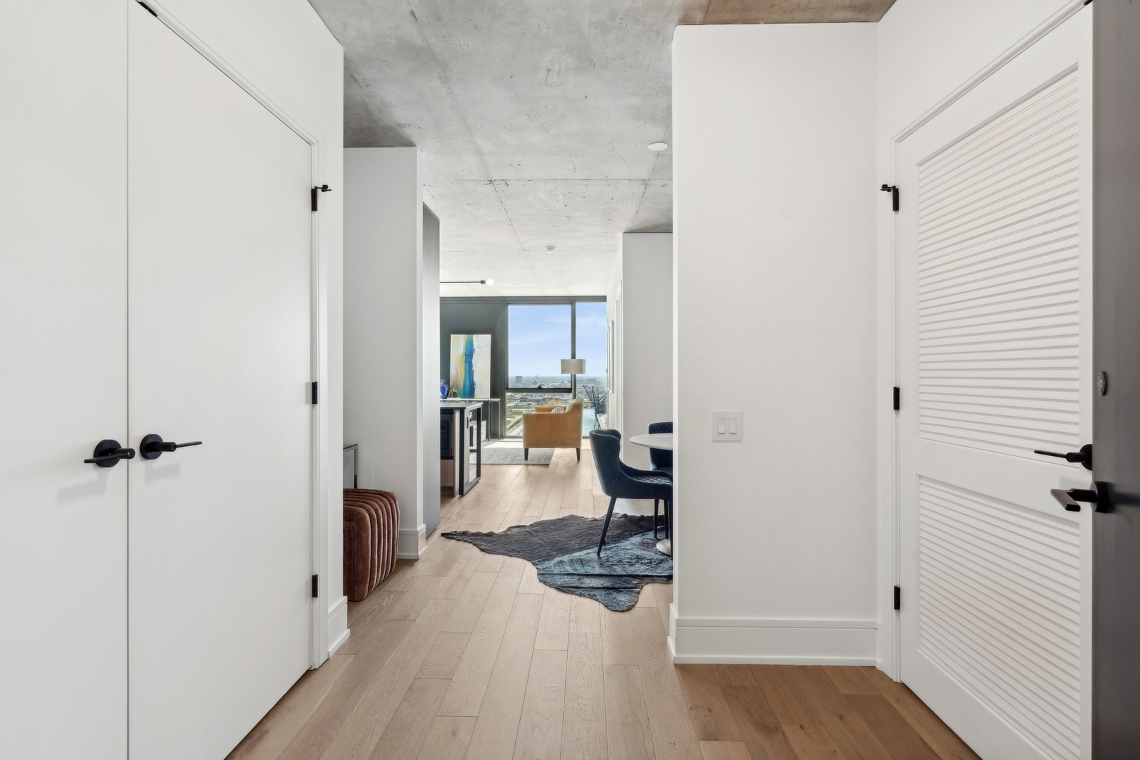 234 West Polk Street, Unit 3503 Chicago, IL 60607 - Photo 3 of 36 a view of a hallway with a wooden table and chairs
