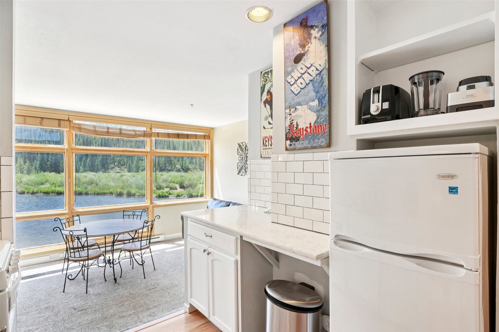 24 River Run Road, Unit 2907 Keystone, CO 80435 - Photo 10 of 37 a kitchen with a stove a refrigerator and a table
