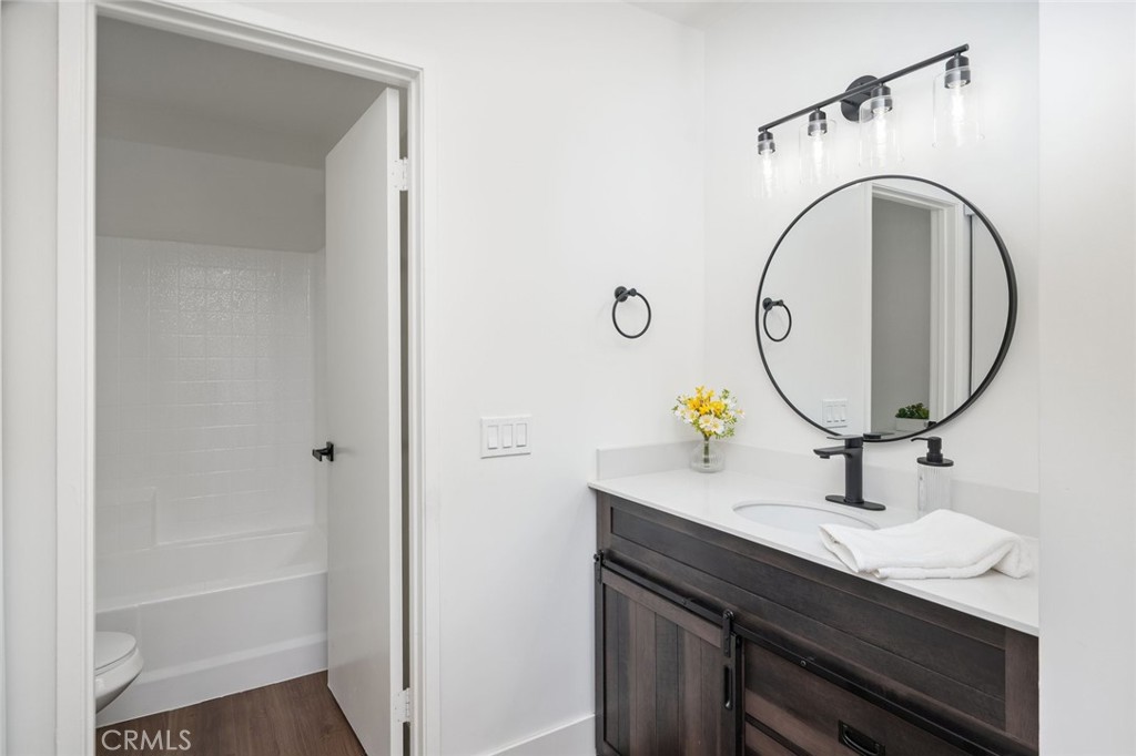 2554 Olive Drive, Unit 84 Palmdale, CA 93550 - Photo 14 of 21 a bathroom with a sink a mirror and a shower