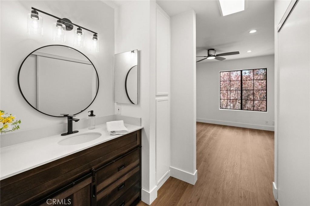 2554 Olive Drive, Unit 84 Palmdale, CA 93550 - Photo 18 of 21 a bathroom with a sink and a mirror