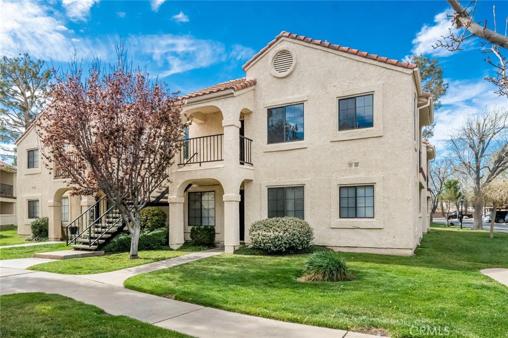 2554 Olive Drive, Unit 84 Palmdale, CA 93550 - Photo 2 of 21 a view of a white house with a yard