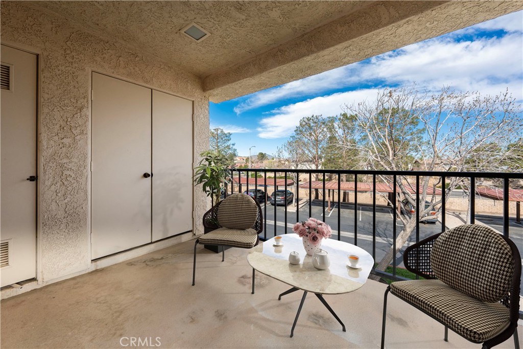2554 Olive Drive, Unit 84 Palmdale, CA 93550 - Photo 8 of 21 a balcony with furniture and a potted plant