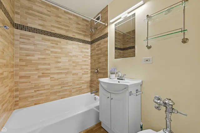 a bathroom with a sink mirror bathtub and toilet