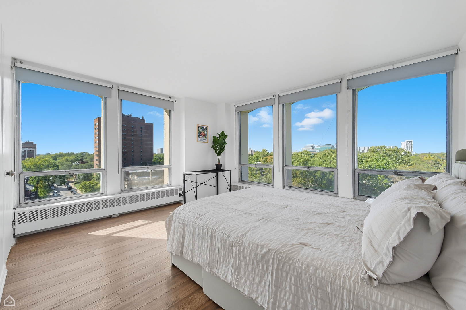 1400 East 55th Place, Unit 702S Chicago, IL 60637 - Photo 6 of 11 a bed sitting in a spacious bedroom next to a large window