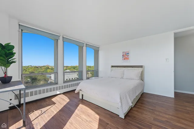 a bedroom with a large bed and a large window