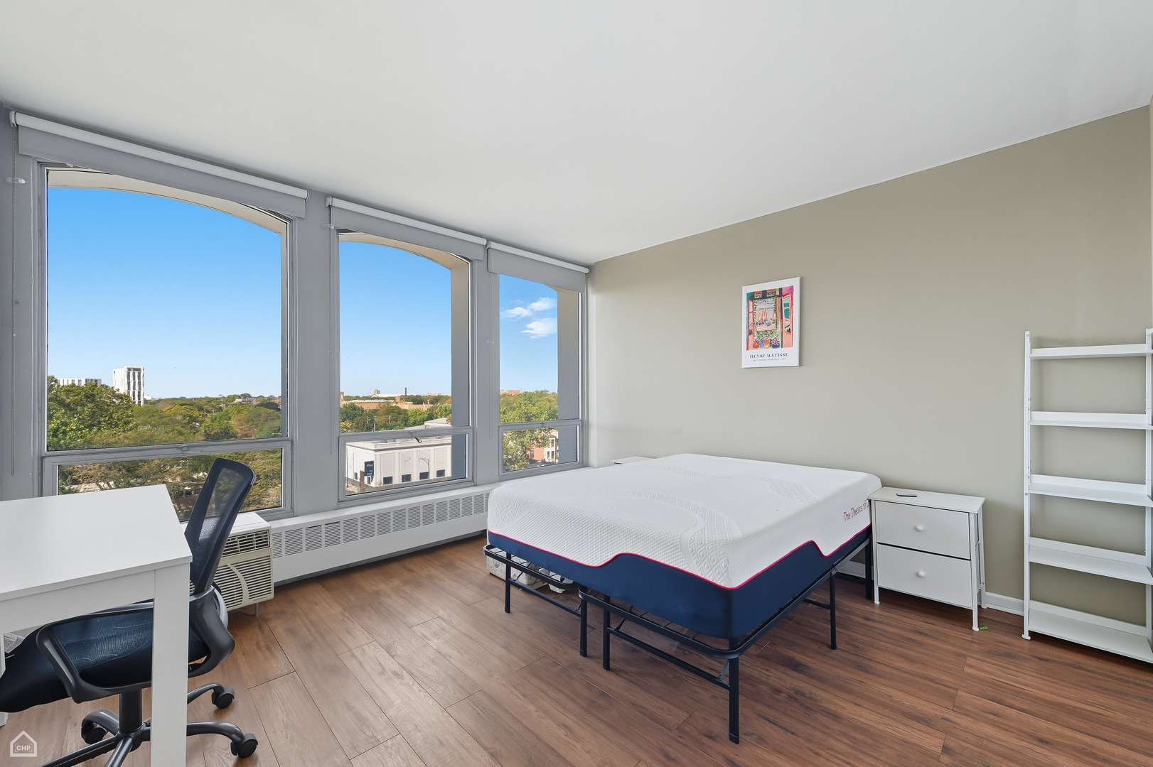 1400 East 55th Place, Unit 702S Chicago, IL 60637 - Photo 9 of 11 a living room with furniture a rug potted plant and a large window