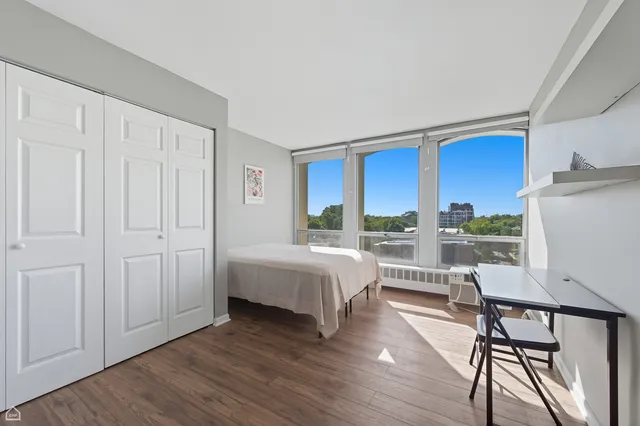 a spacious bedroom with a bed and a table