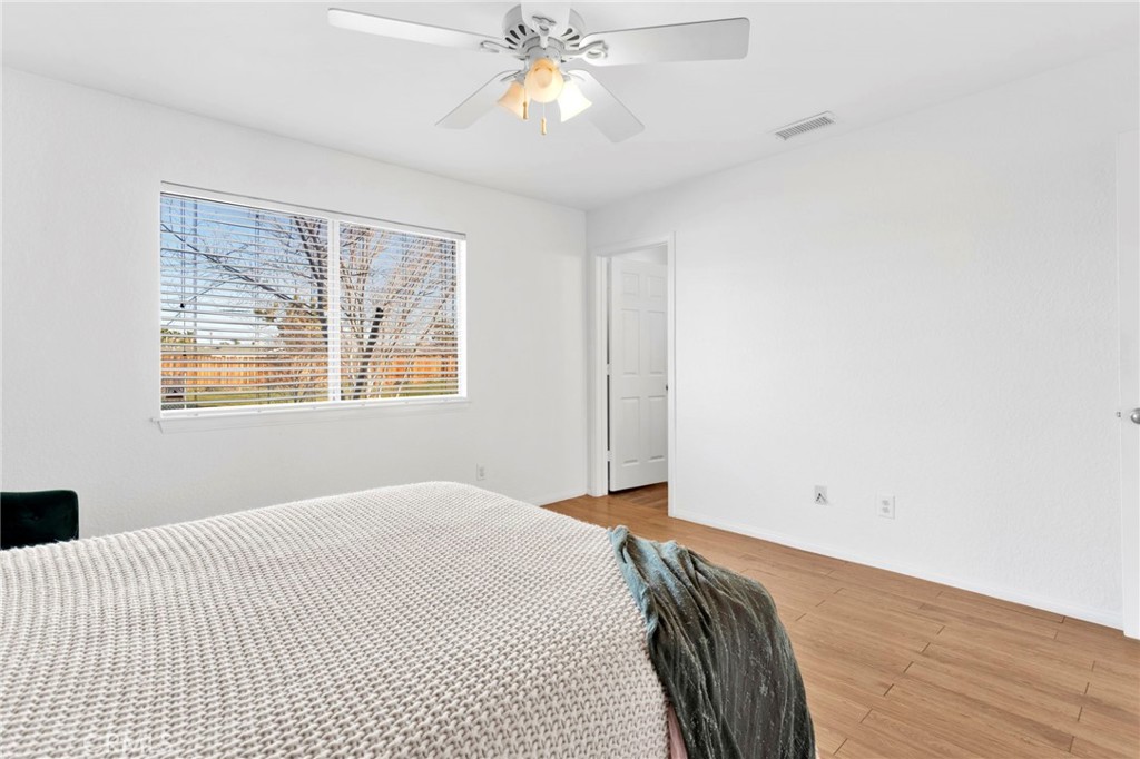 12655 Pocono Road Apple Valley, CA 92308 - Photo 22 of 52 a bedroom with a bed and a chandelier