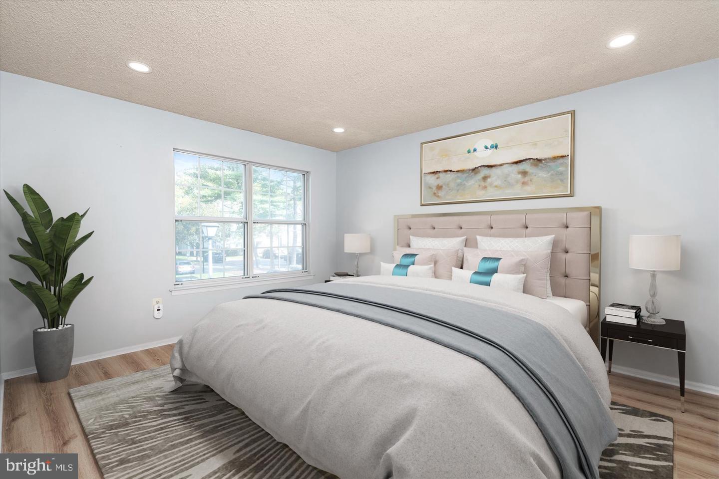 110 Versailles Court Hamilton, NJ 08619 - Photo 11 of 19 a bedroom with a large bed and a potted plant