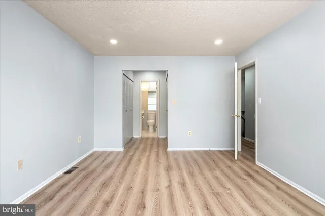 a view of room with window and hardwood floor