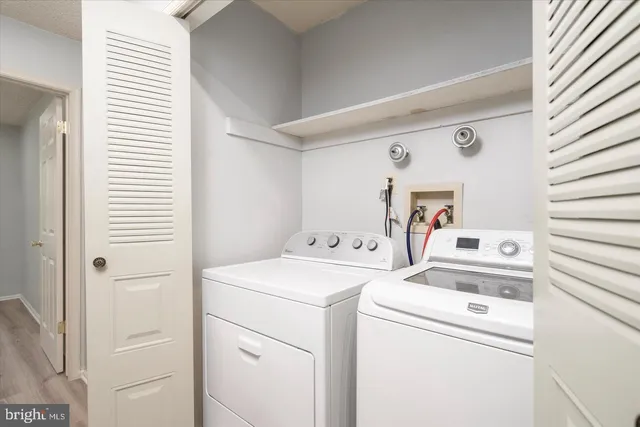 a view of storage and utility room with washer and dryer