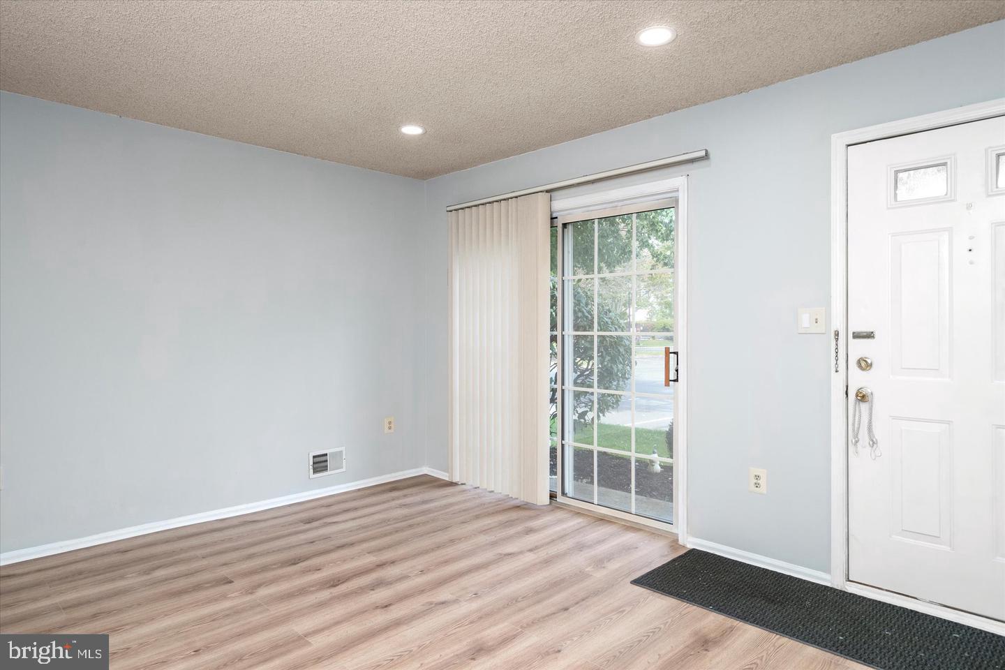 110 Versailles Court Hamilton, NJ 08619 - Photo 9 of 19 an empty room with wooden floor and windows