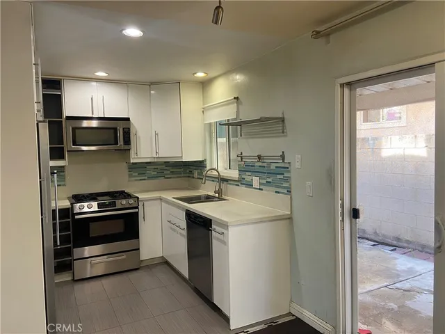 a view of a livingroom with wooden floor and staircase