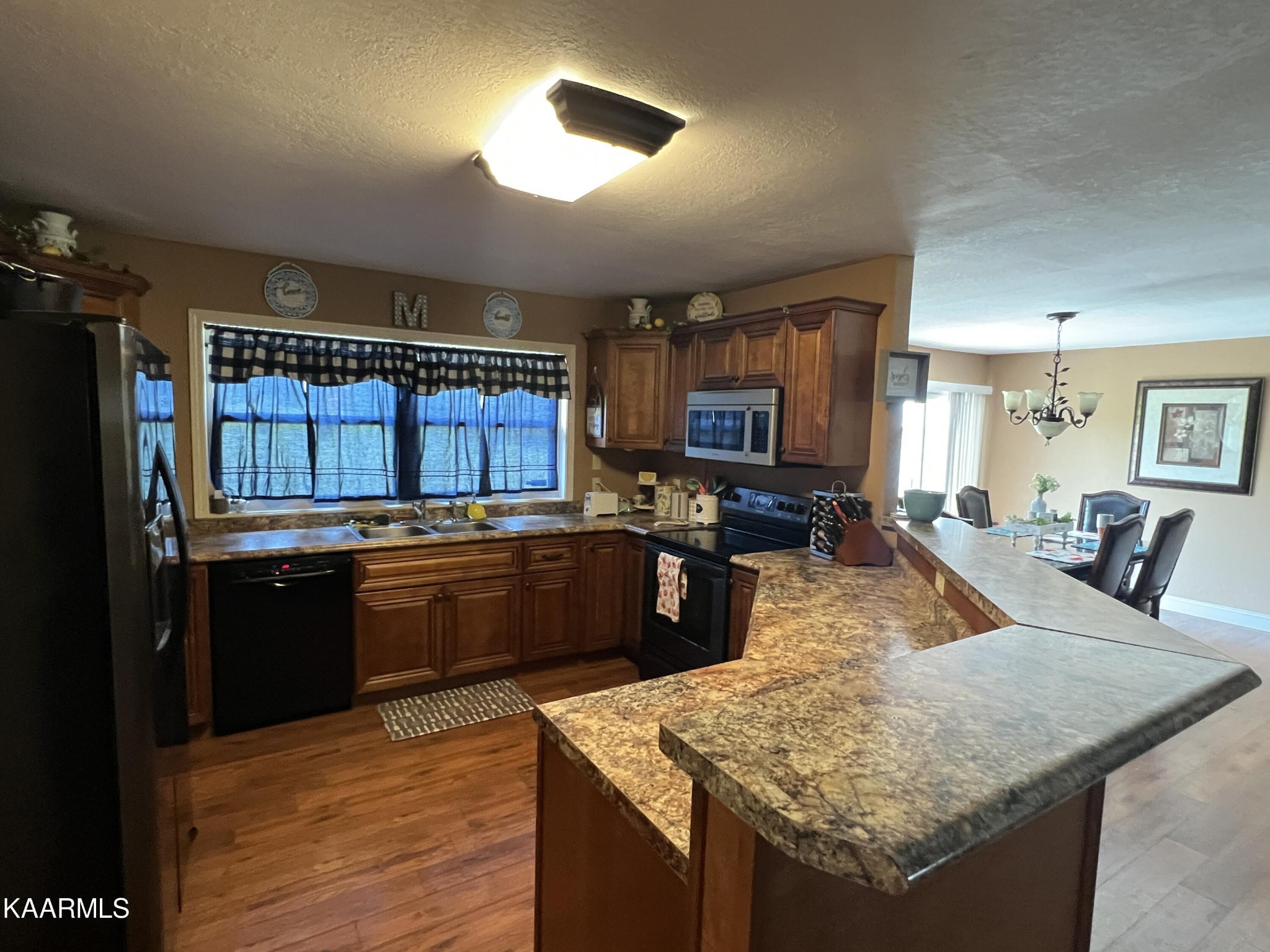 502 Claiborne Road La Follette, TN 37766 - Photo 7 of 28 a kitchen with stainless steel appliances granite countertop sink stove refrigerator and cabinets