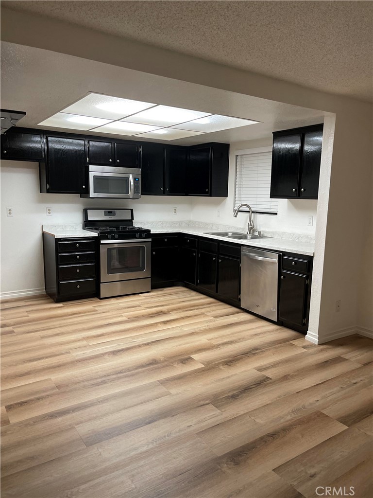 a kitchen with stainless steel appliances and view of kitchen