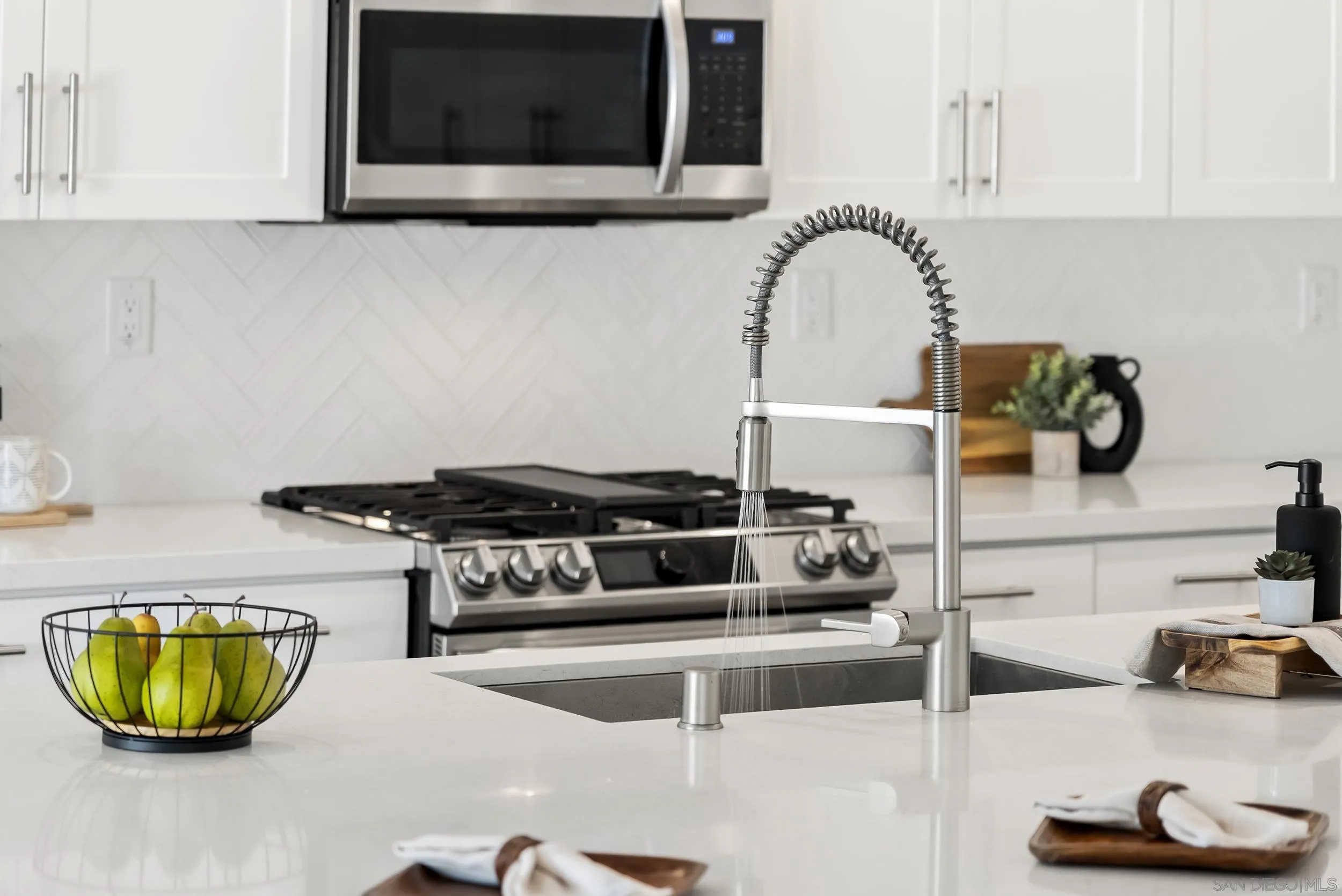 3304 Telaga Road Carlsbad, CA 92010 - Photo 14 of 60 a kitchen with a stove and a sink