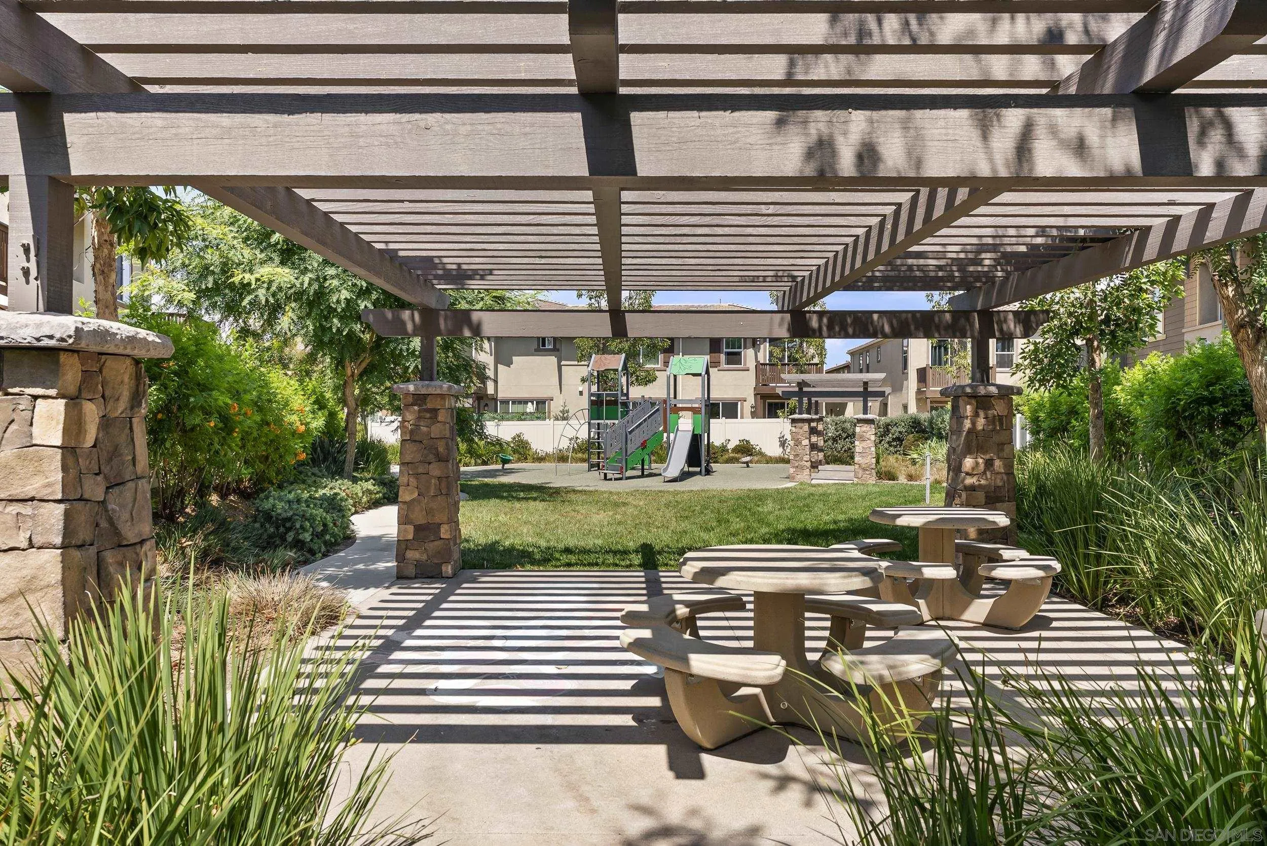 3304 Telaga Road Carlsbad, CA 92010 - Photo 41 of 60 a view of a patio with table and chairs potted plants