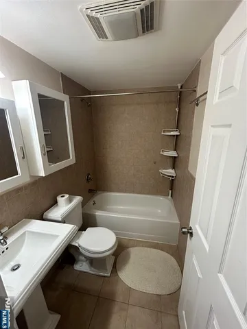 a bathroom with a sink a toilet and a bathtub
